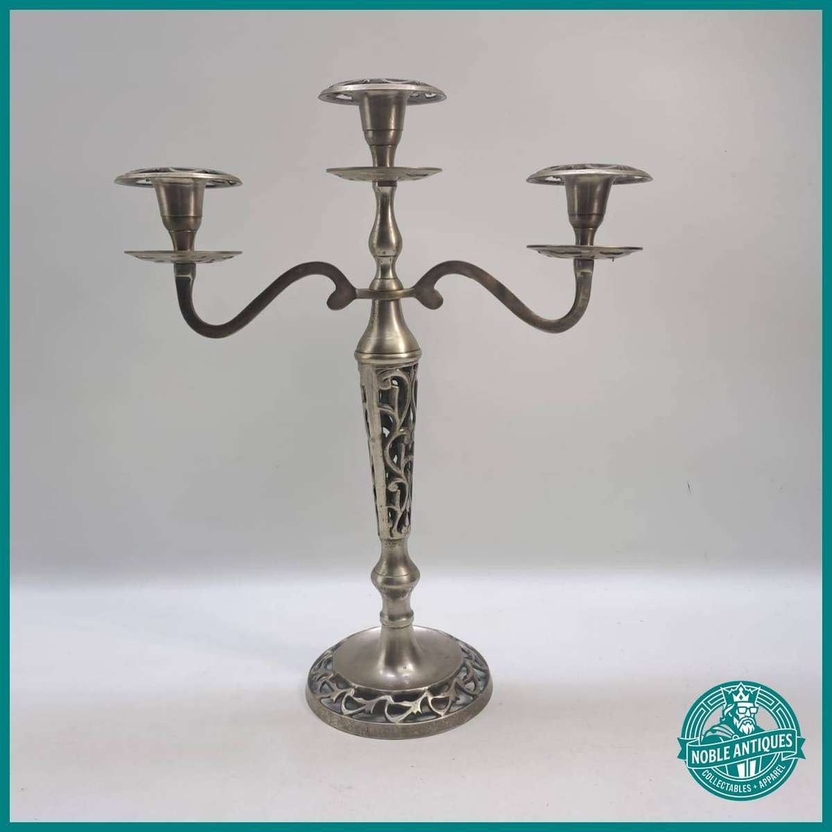 Silver-plate candelabra featuring intricate openwork stem and base design