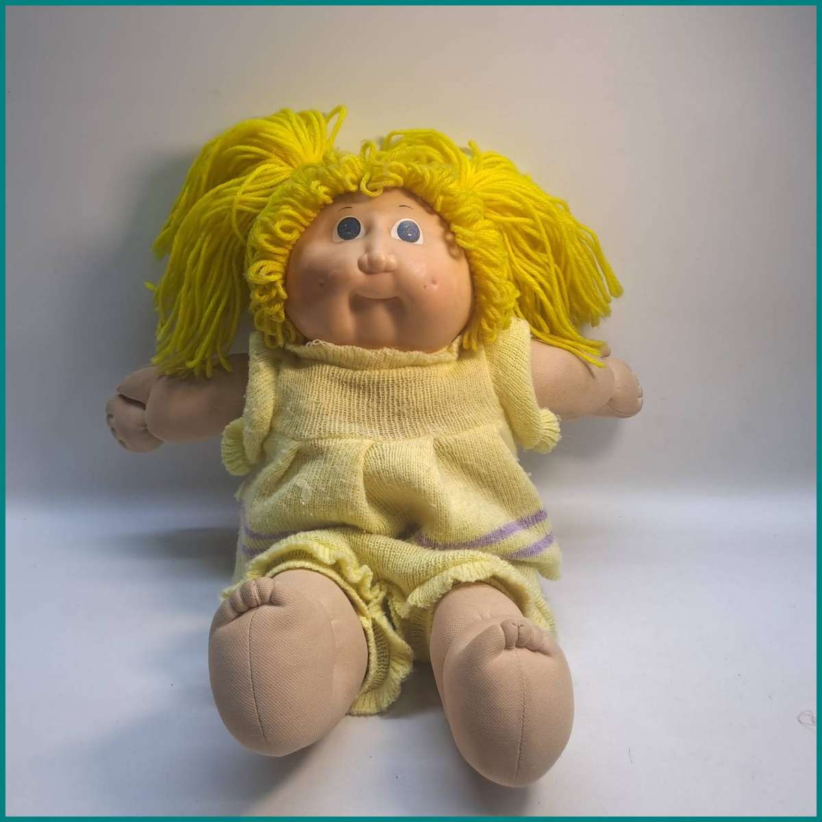 Vintage Cabbage Patch Kids doll features bright yellow yarn hair