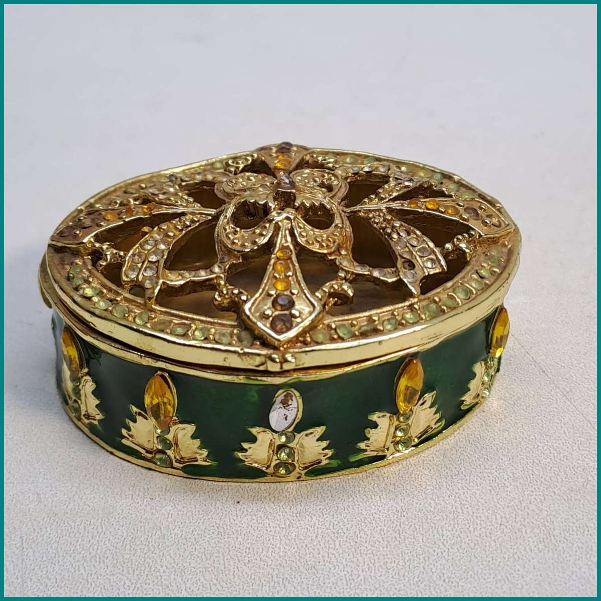 Vintage ornate, oval-shaped metal hinged trinket box