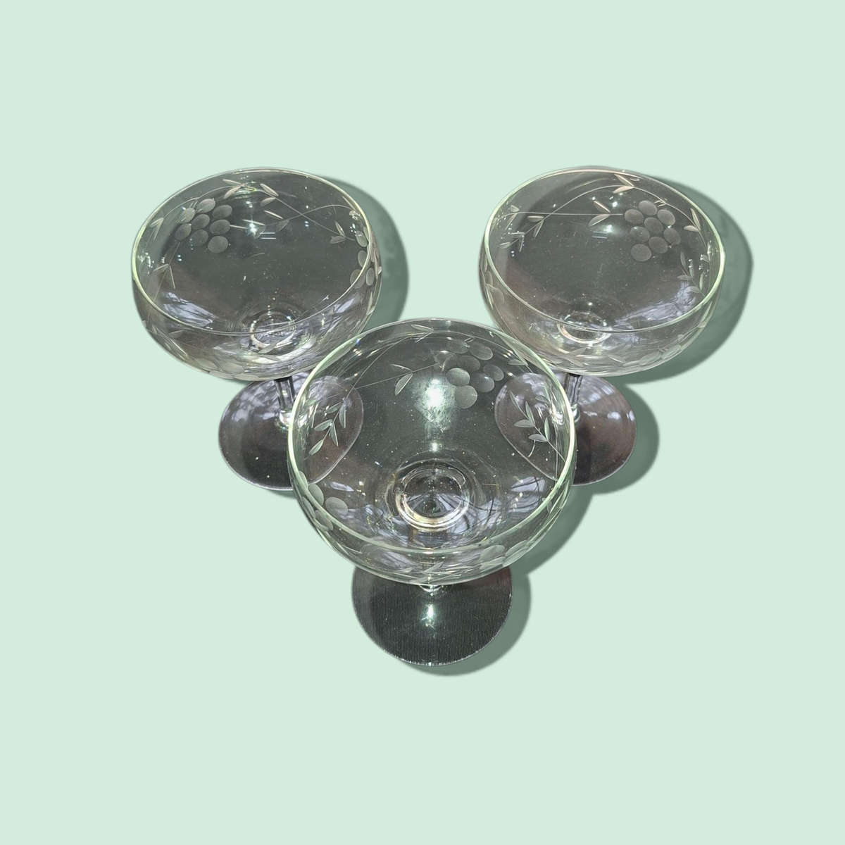 Champagne glasses with etched grapes motif