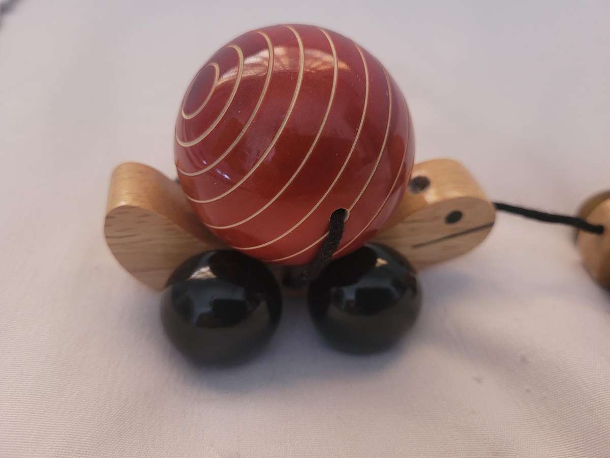 HAND MADE WOODEN TORTOISE-TRIPPLE PULL ALONG, FACINATING TOY. WHEELS TURN THE SHELLS. UNUSED.