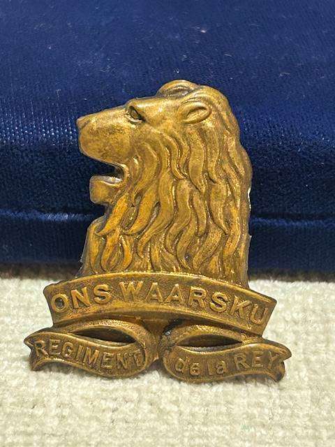 Vintage brass cap badge of the South African Army's Regiment de la Rey