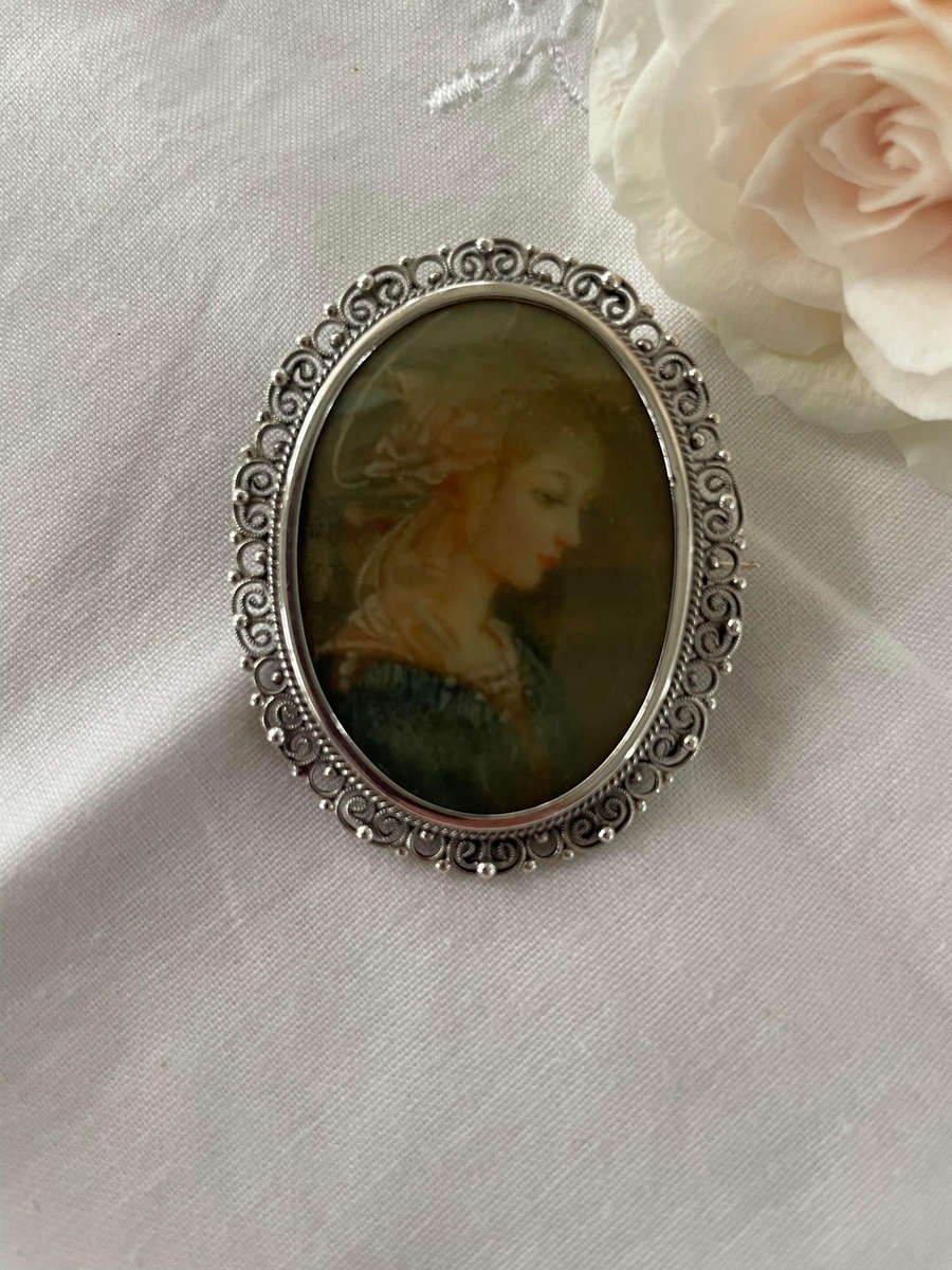 Delicate as a rose petal! Hand painted young lady set in solid silver (800) frame/ornate scrolling!!
