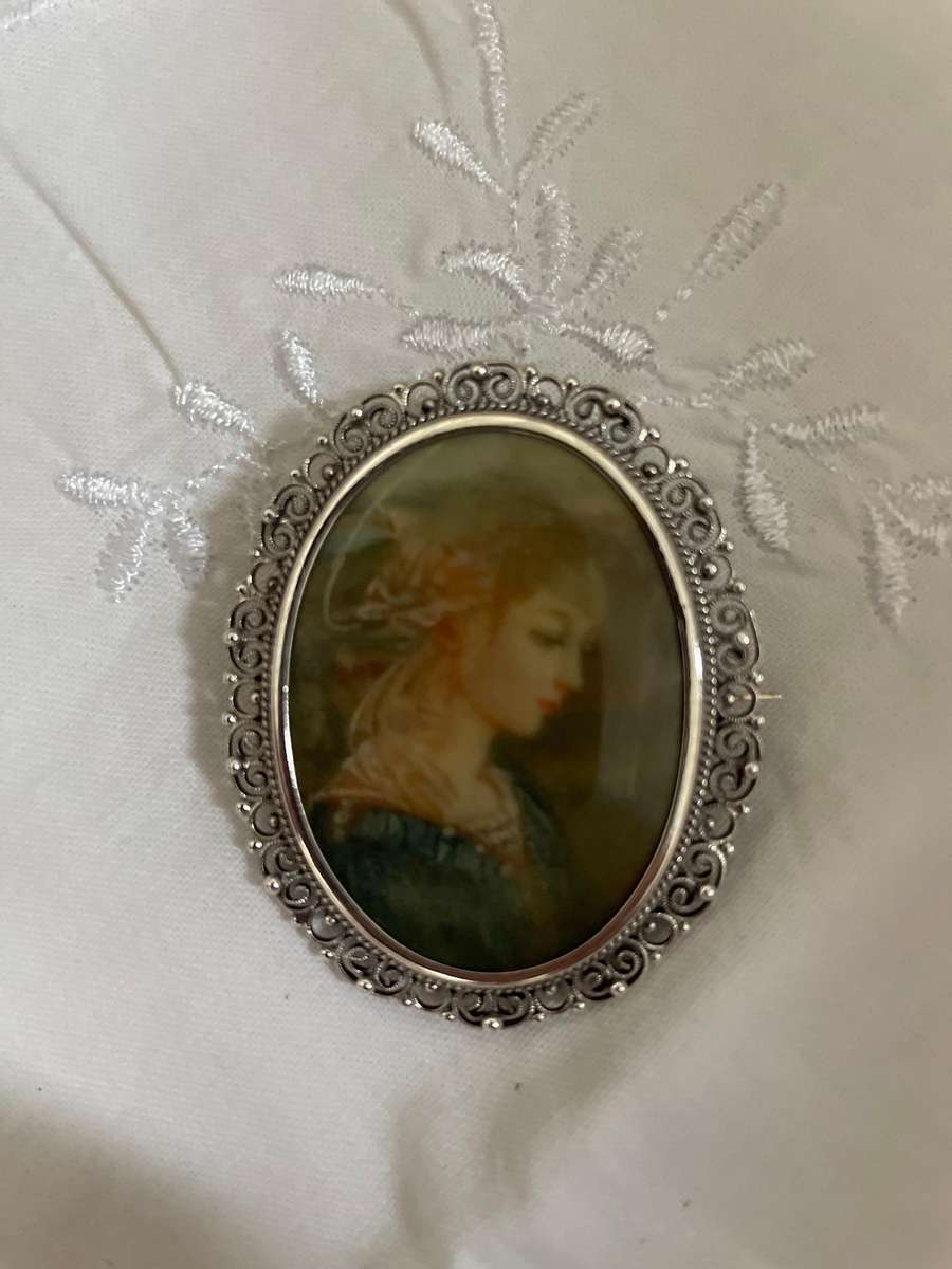 Delicate as a rose petal! Hand painted young lady set in solid silver (800) frame/ornate scrolling!!