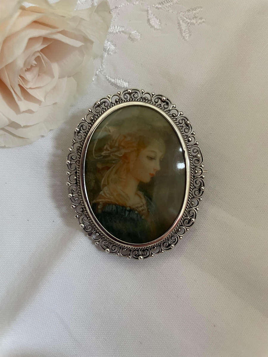 Delicate as a rose petal! Hand painted young lady set in solid silver (800) frame/ornate scrolling!!