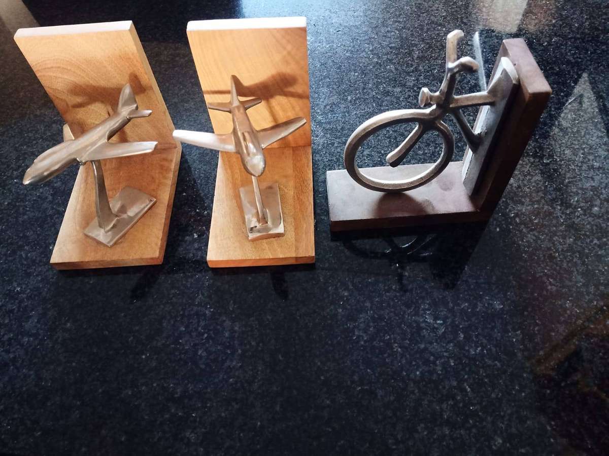 These bookends are crafted from mango wood and nickel aeroplanes. Pewter bicycle