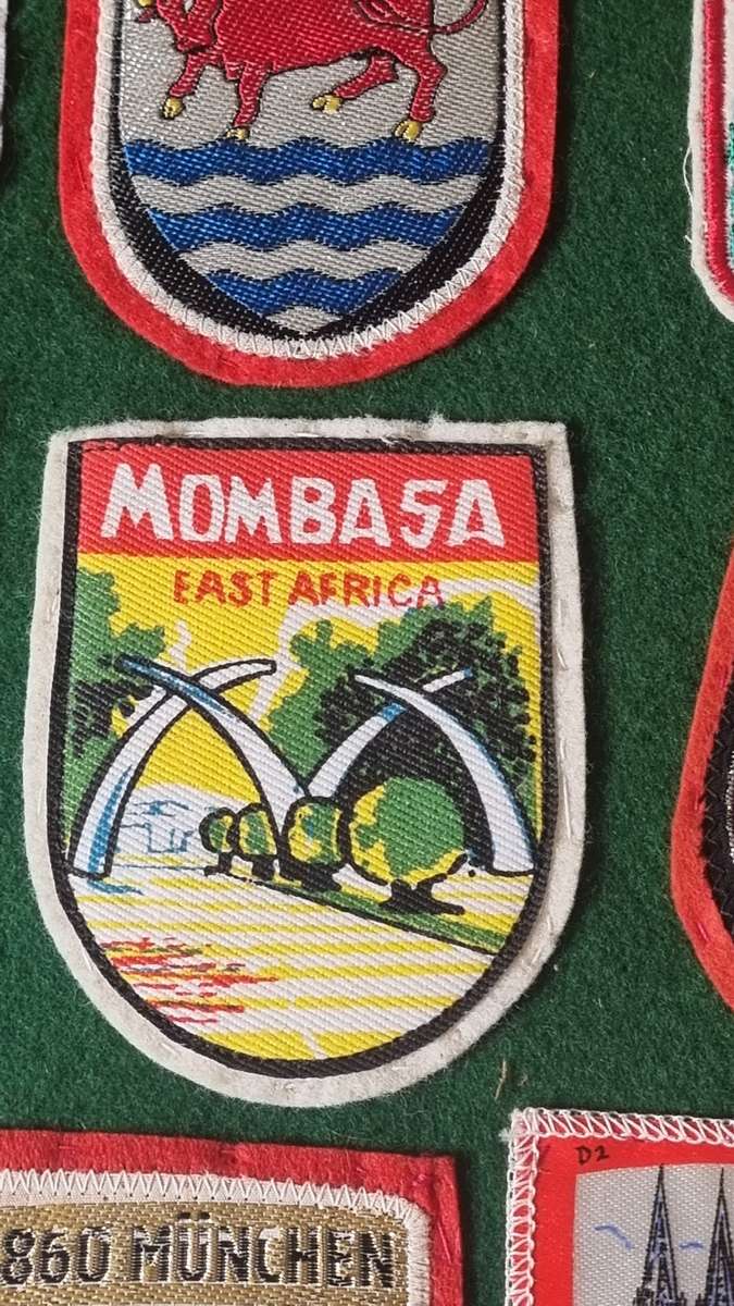 43 x Cloth Souvenir Badges in Excellent Condition neatly sewn patches, onto felt. Mombasa, Europe.