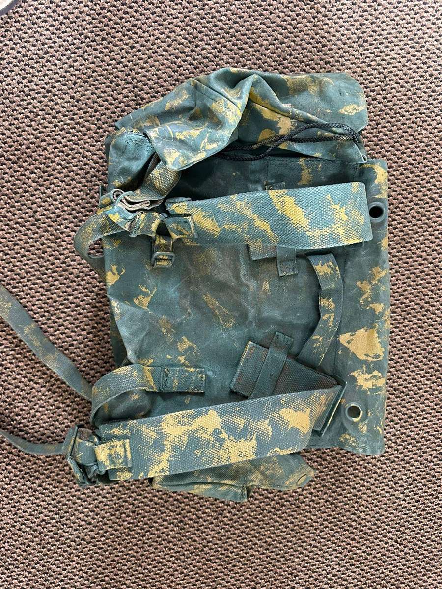 Rhodesian smaller back pack with water bottle side pouch and another open side pouch. measures 47x32