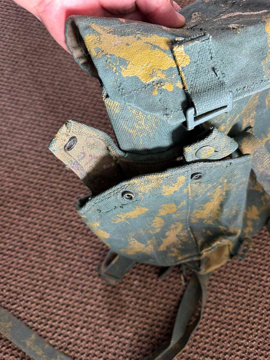 Rhodesian smaller back pack with water bottle side pouch and another open side pouch. measures 47x32