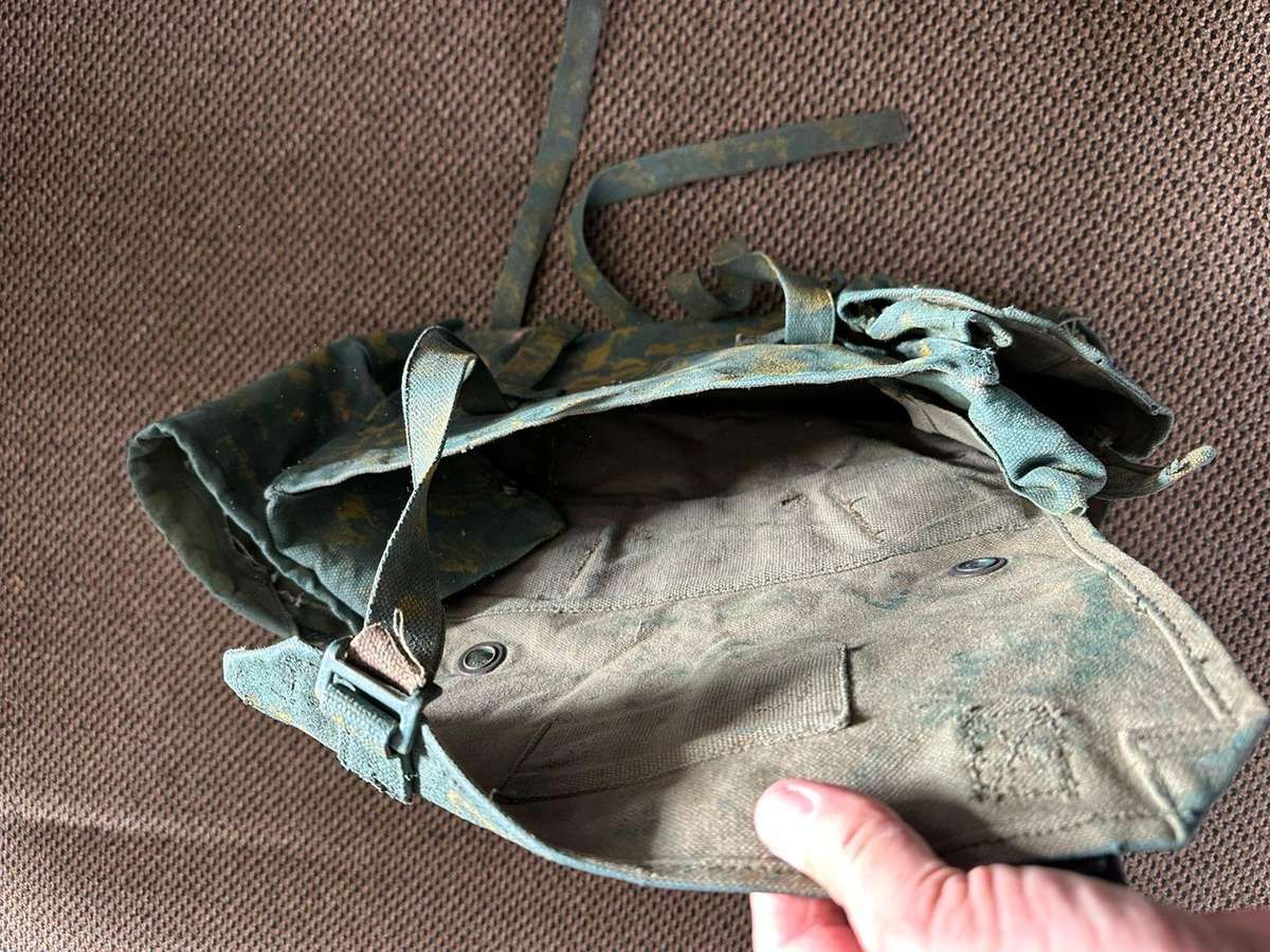 Rhodesian smaller back pack with water bottle side pouch and another open side pouch. measures 47x32