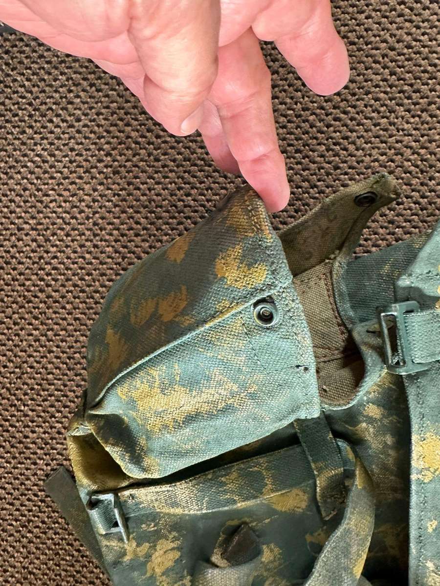 Rhodesian smaller back pack with water bottle side pouch and another open side pouch. measures 47x32