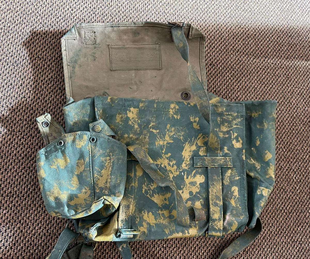 Rhodesian smaller back pack with water bottle side pouch and another open side pouch. measures 47x32