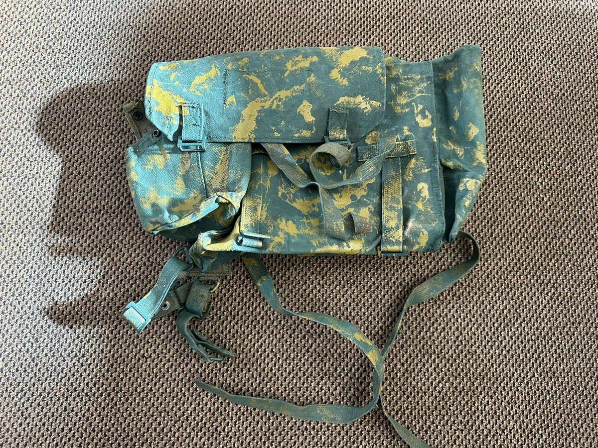 Rhodesian smaller back pack with water bottle side pouch and another open side pouch. measures 47x32