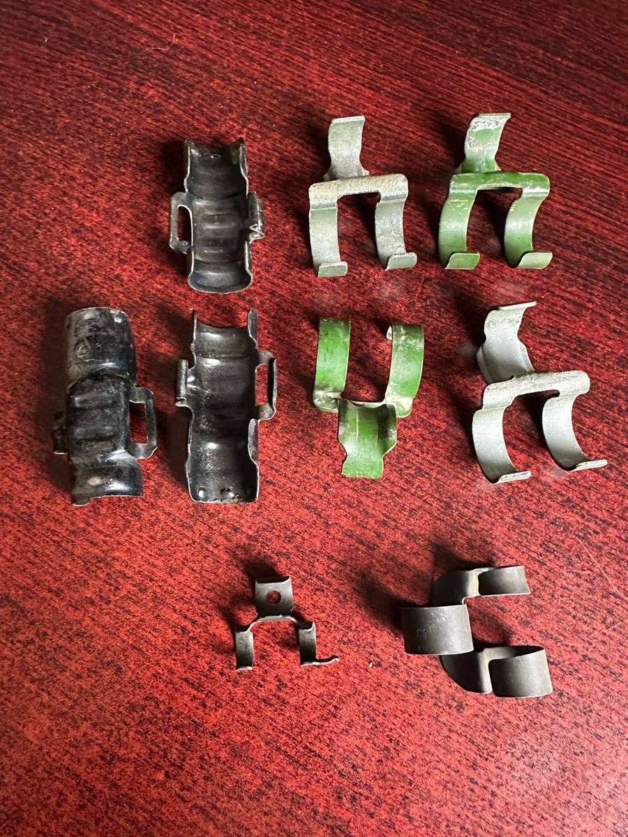 Selection of machine gun belt clips. 9 In total.