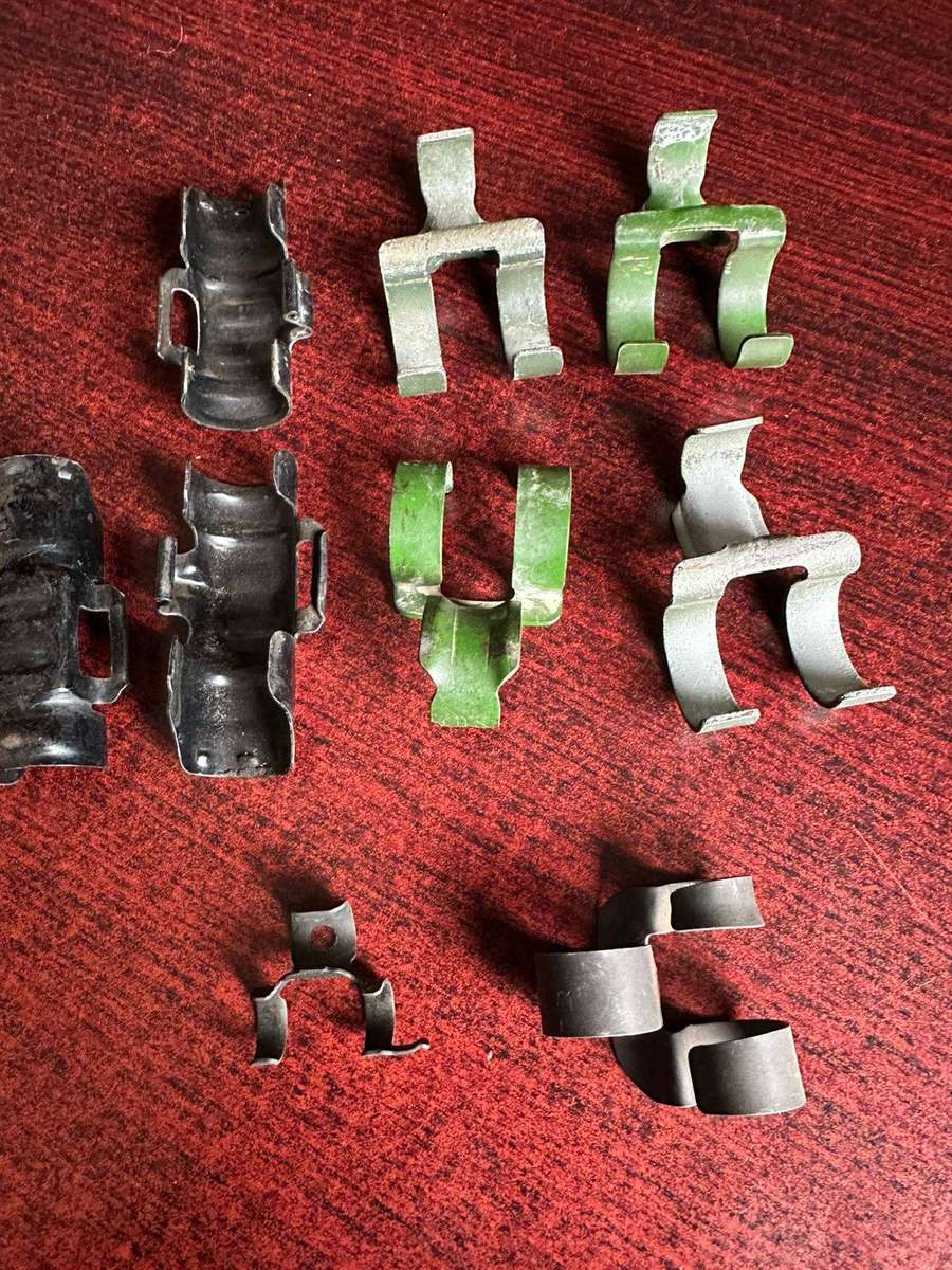 Selection of machine gun belt clips. 9 In total.