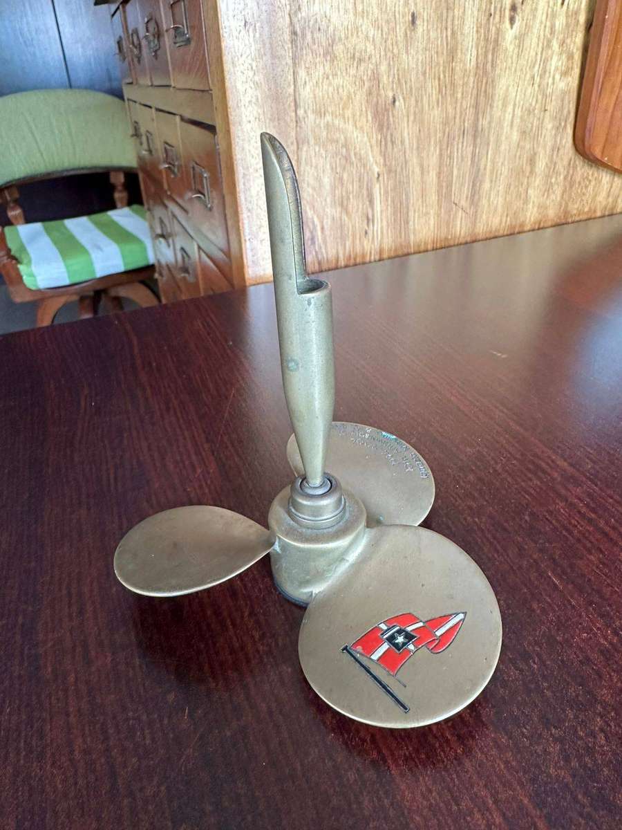 Brass propeller made into a pen holder. Diameter at the bottom 11,5cm, height 13 cm.