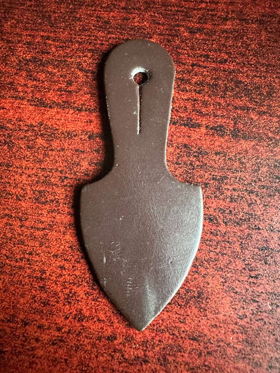 Original leather backing for pocket fob badge.