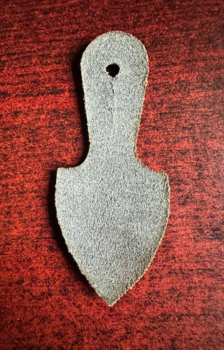 Original leather backing for pocket fob badge.