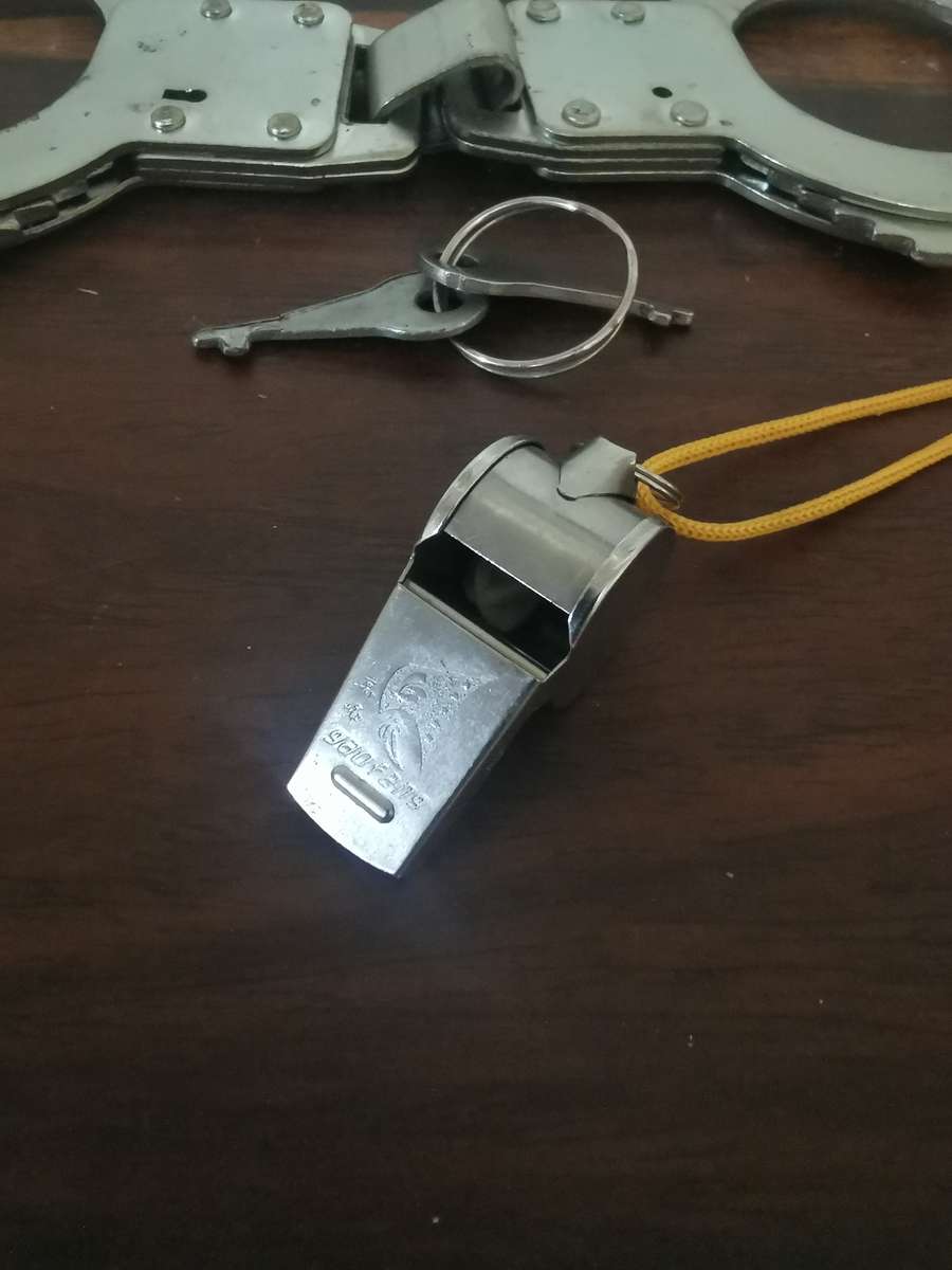 Collection of Whistles with a Pair of Handcuffs