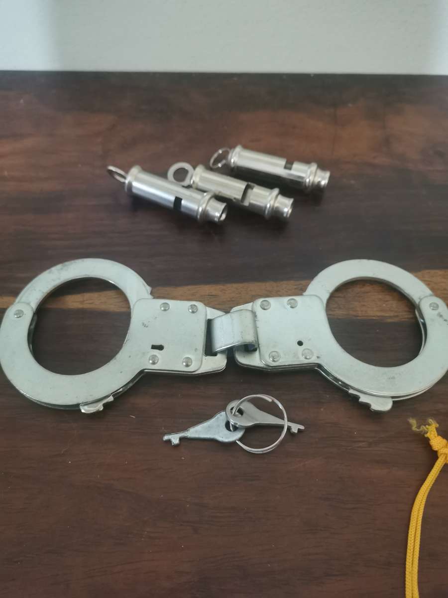 Collection of Whistles with a Pair of Handcuffs
