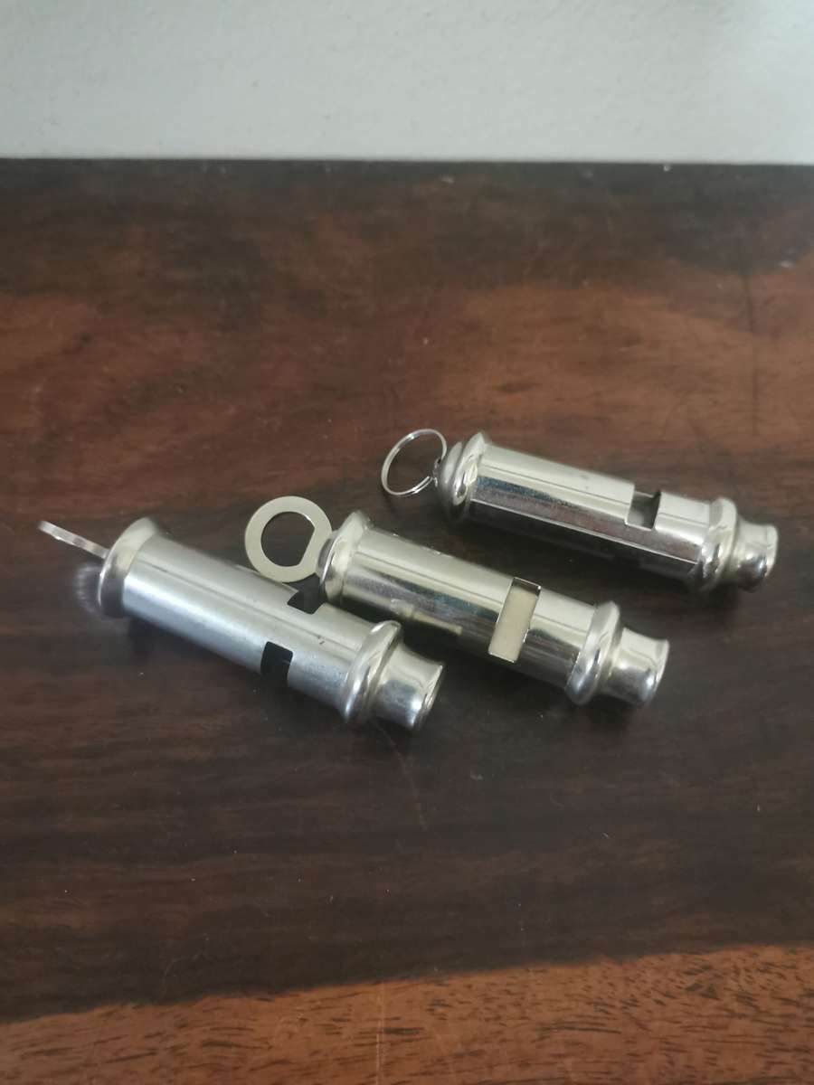 Collection of Whistles with a Pair of Handcuffs