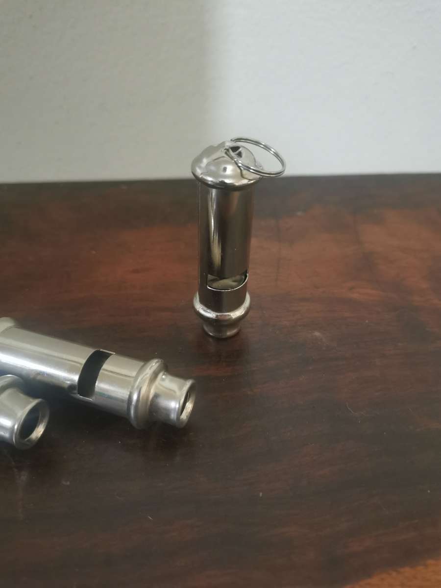 Collection of Whistles with a Pair of Handcuffs