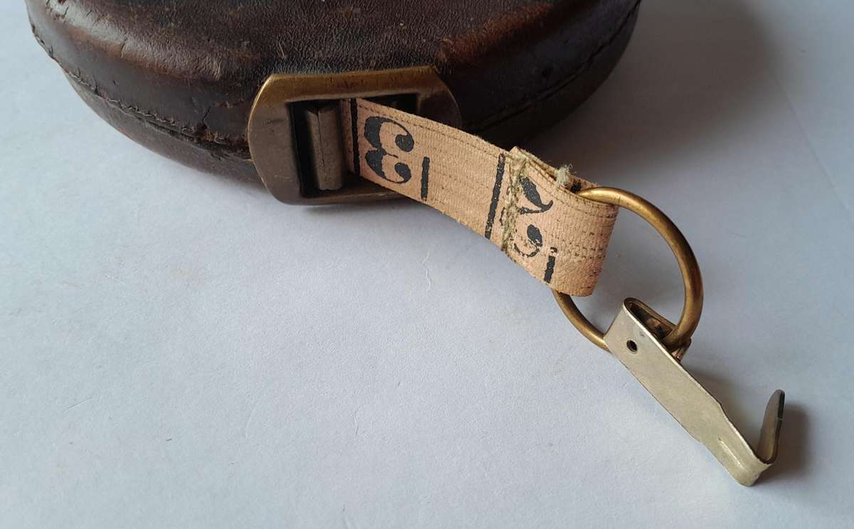 Antique Leather Cased 66ft Wind Up Measuring Tape with Brass Handle.