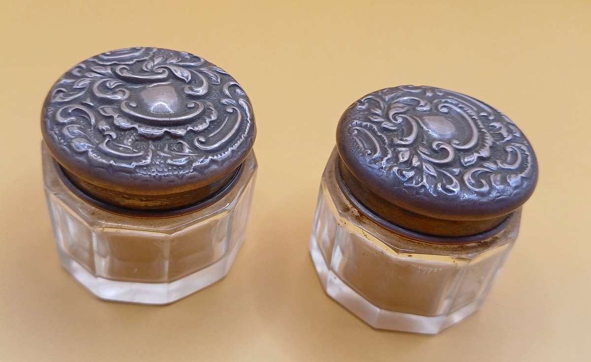 Two small marked silver and glass vanity jars lion facing left