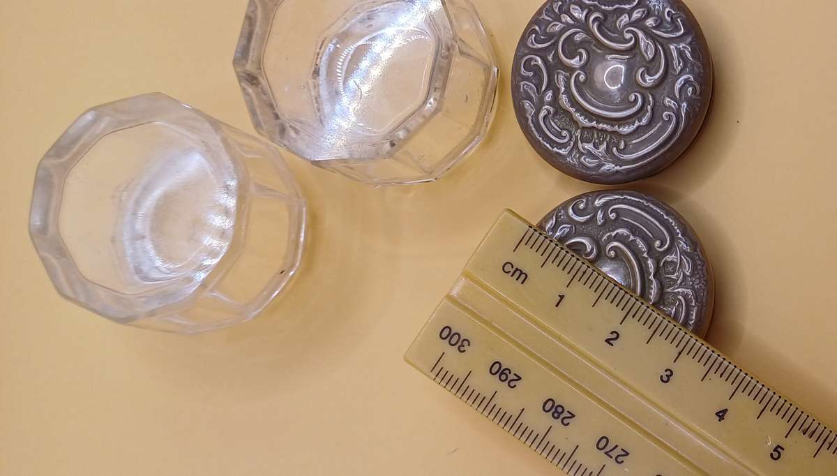 Two small marked silver and glass vanity jars lion facing left