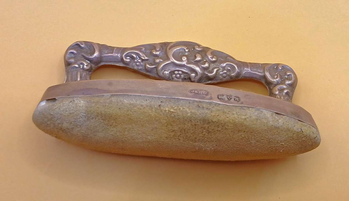 Marked silver nail buffer lion facing left