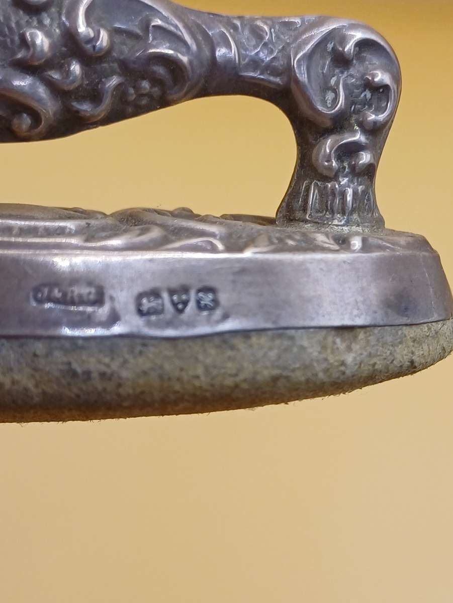 Marked silver nail buffer lion facing left