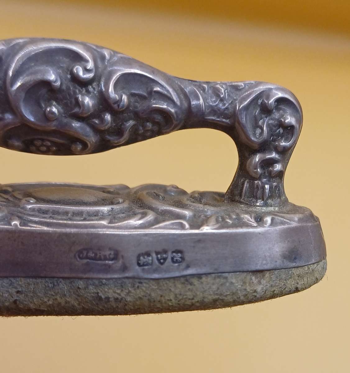 Marked silver nail buffer lion facing left