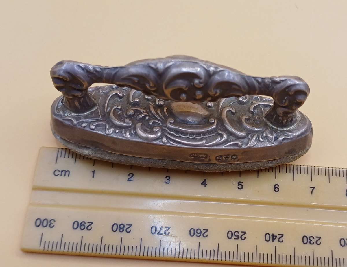 Marked silver nail buffer lion facing left