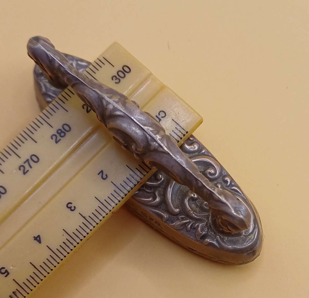 Marked silver nail buffer lion facing left