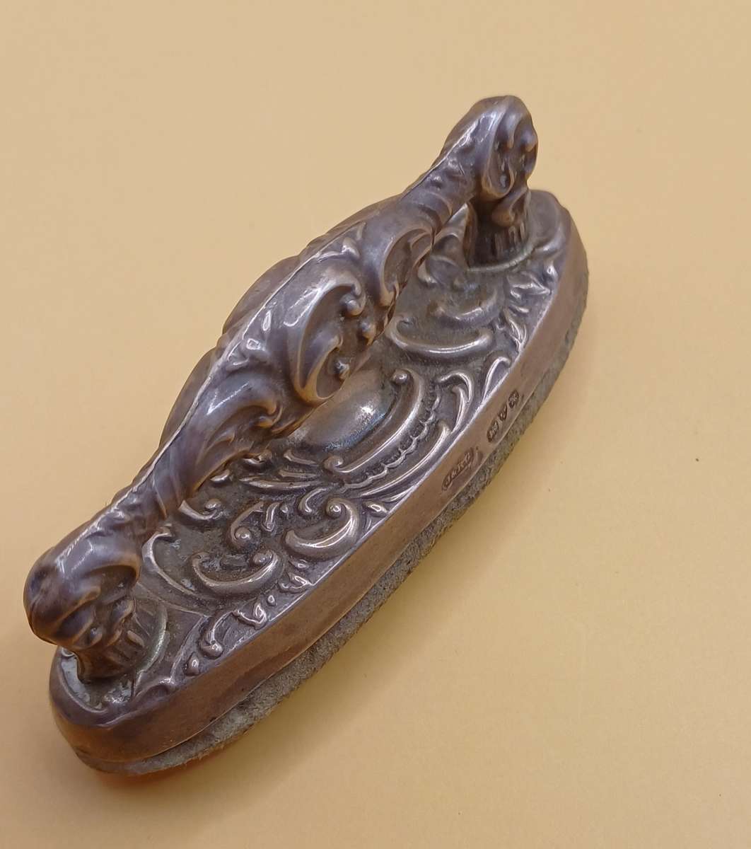 Marked silver nail buffer lion facing left