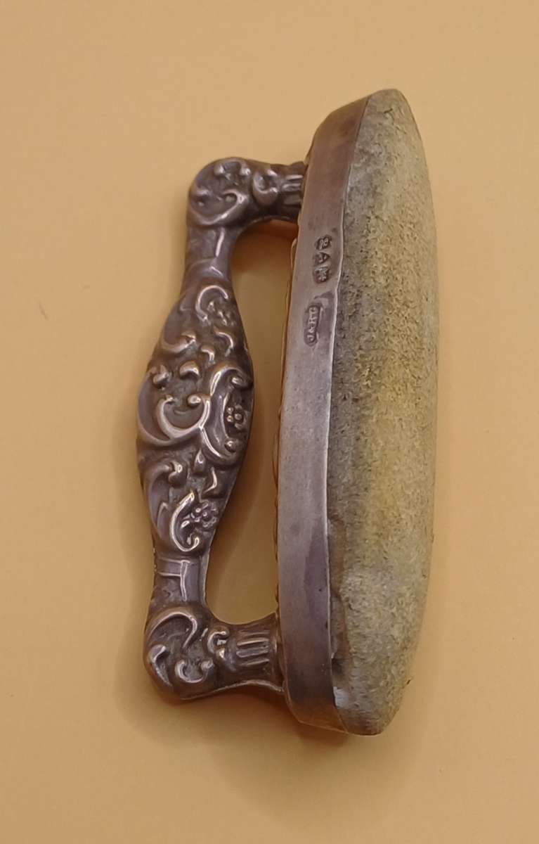 Marked silver nail buffer lion facing left