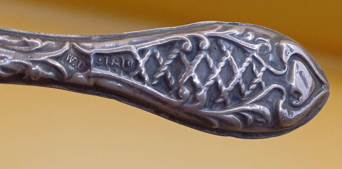 Marked silver nail file lion facing left
