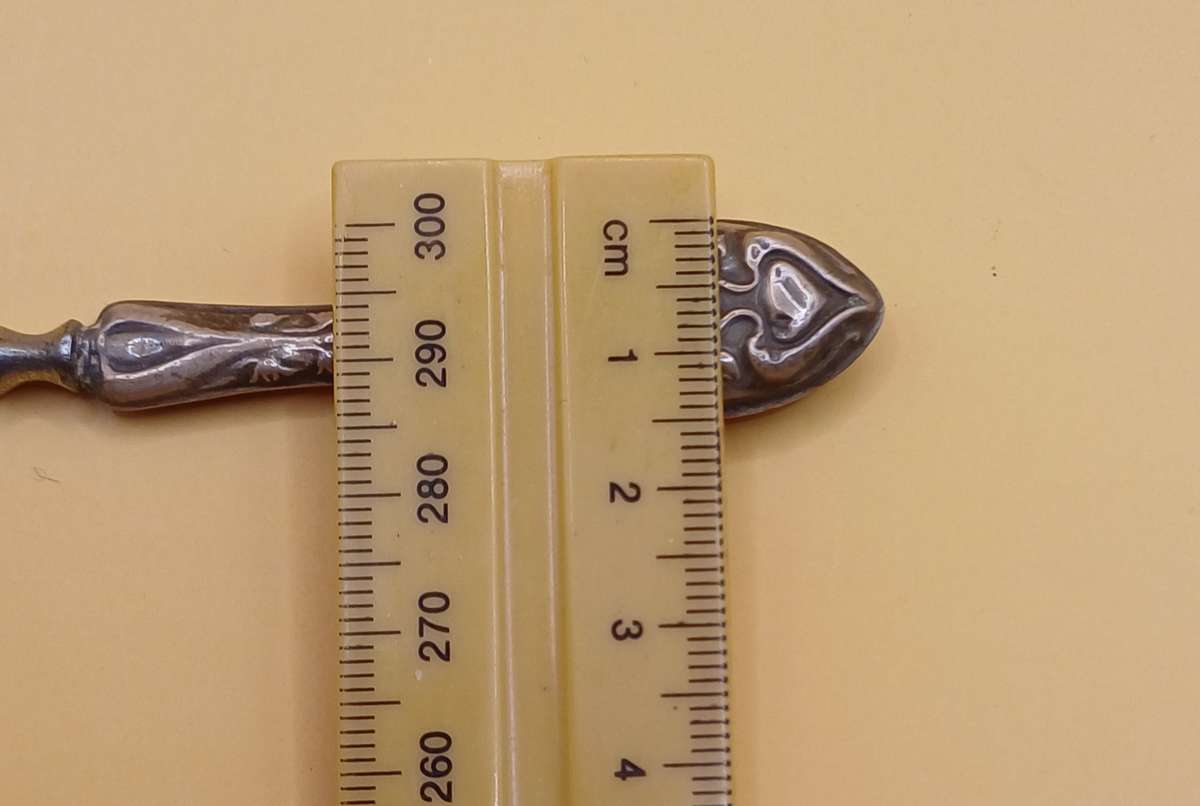 Marked silver nail file lion facing left