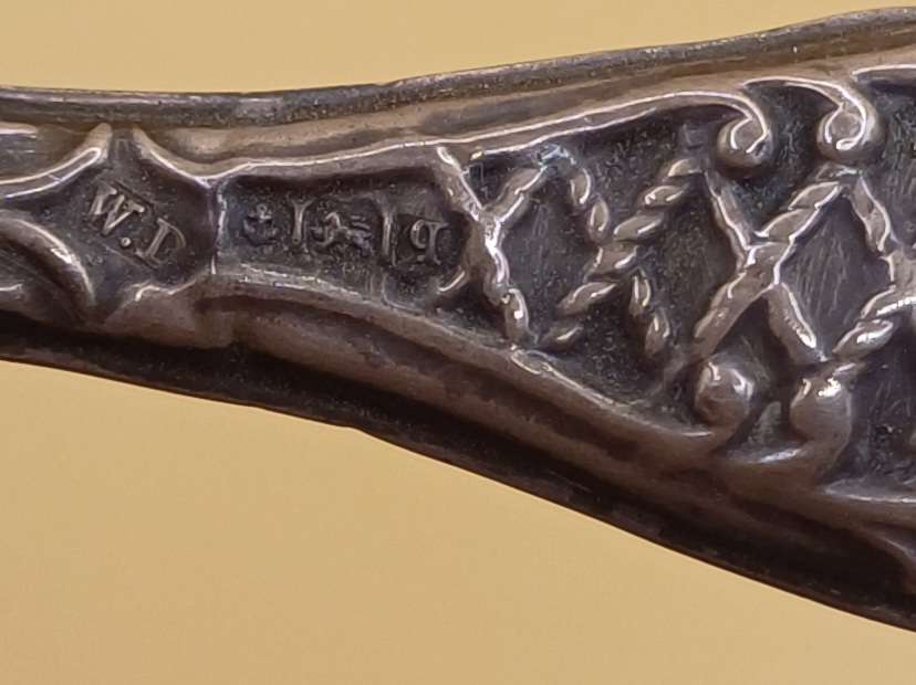 Marked silver nail file lion facing left