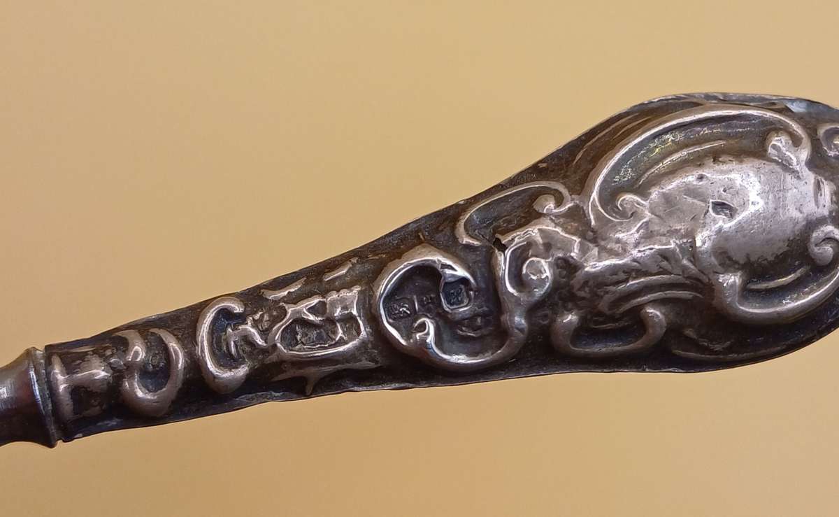 Marked silver lion facing left