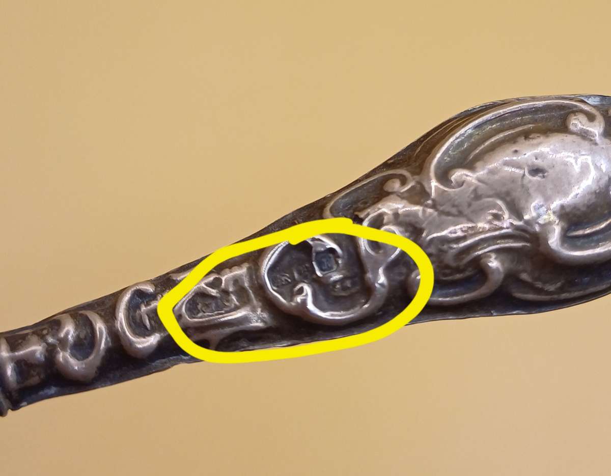 Marked silver lion facing left