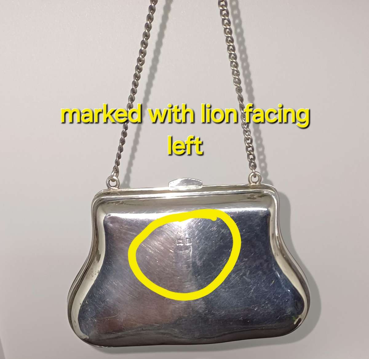 Antique silver coin purse marked with lion facing left