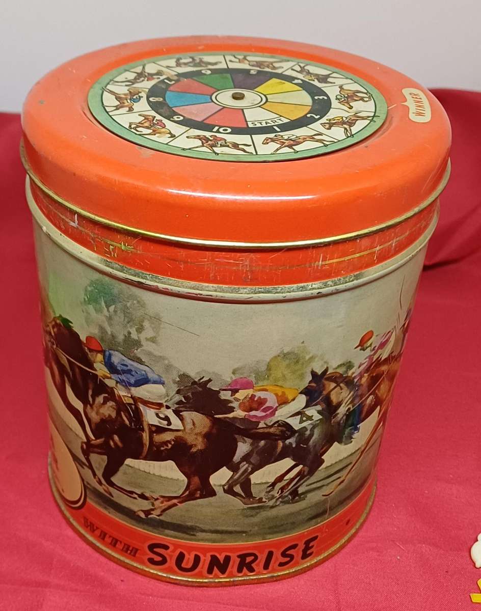 Collectable tin full of vintage plastic charms