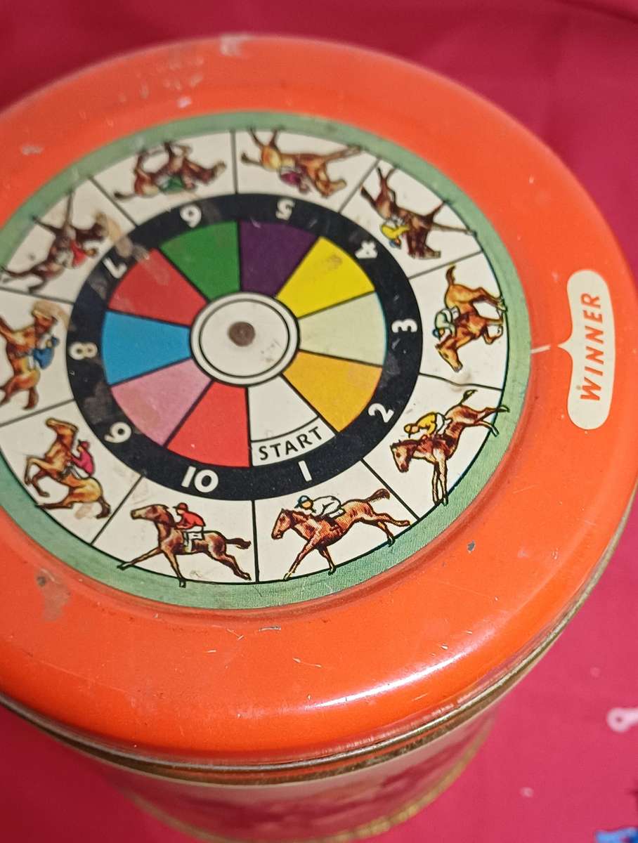 Collectable tin full of vintage plastic charms