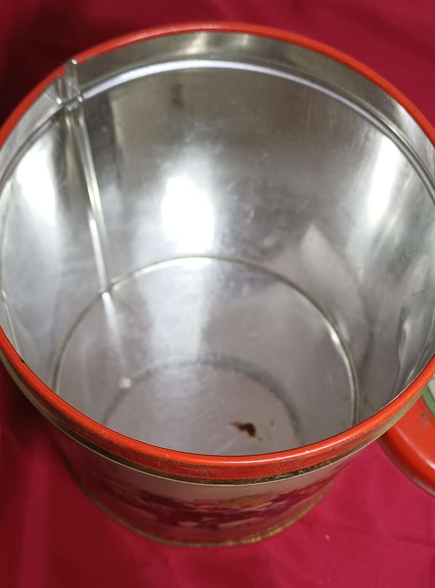 Collectable tin full of vintage plastic charms