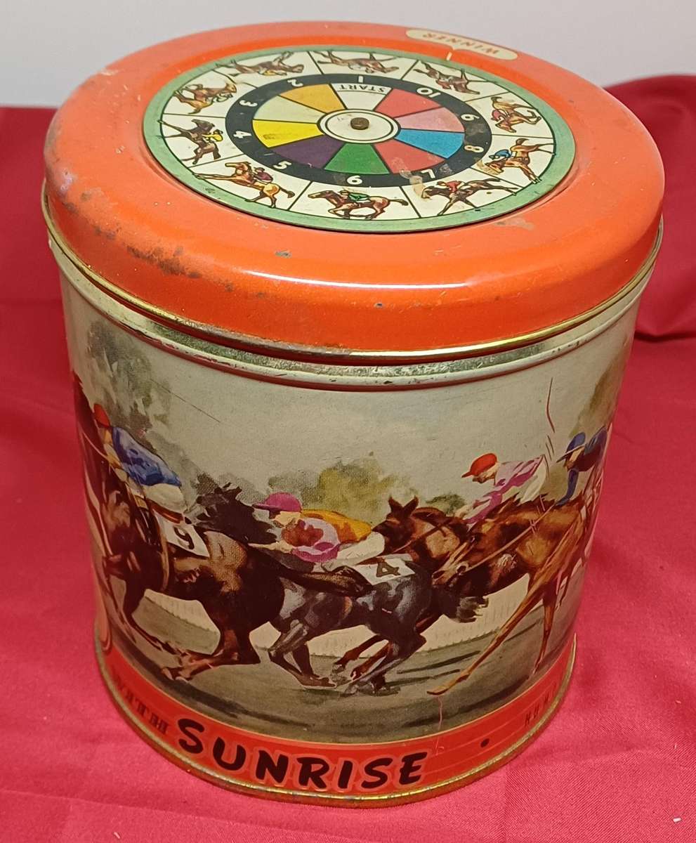 Collectable tin full of vintage plastic charms