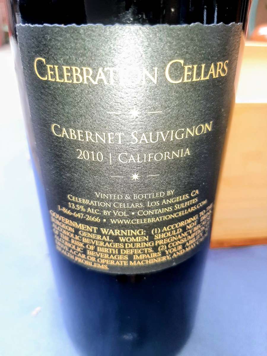 Cabernet Sauvignon, presented in a wooden gift box. The bottle is wrapped in plastic and packing