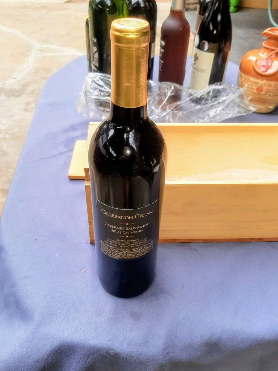 Cabernet Sauvignon, presented in a wooden gift box. The bottle is wrapped in plastic and packing
