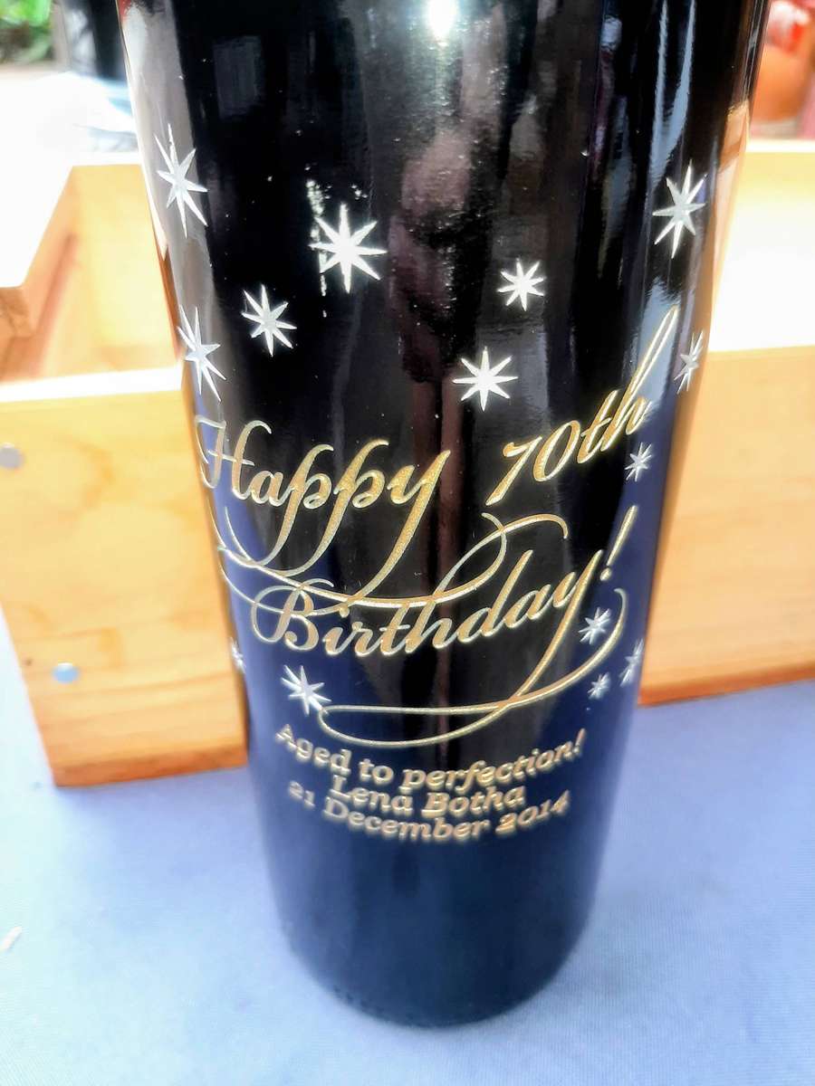 Cabernet Sauvignon, presented in a wooden gift box. The bottle is wrapped in plastic and packing