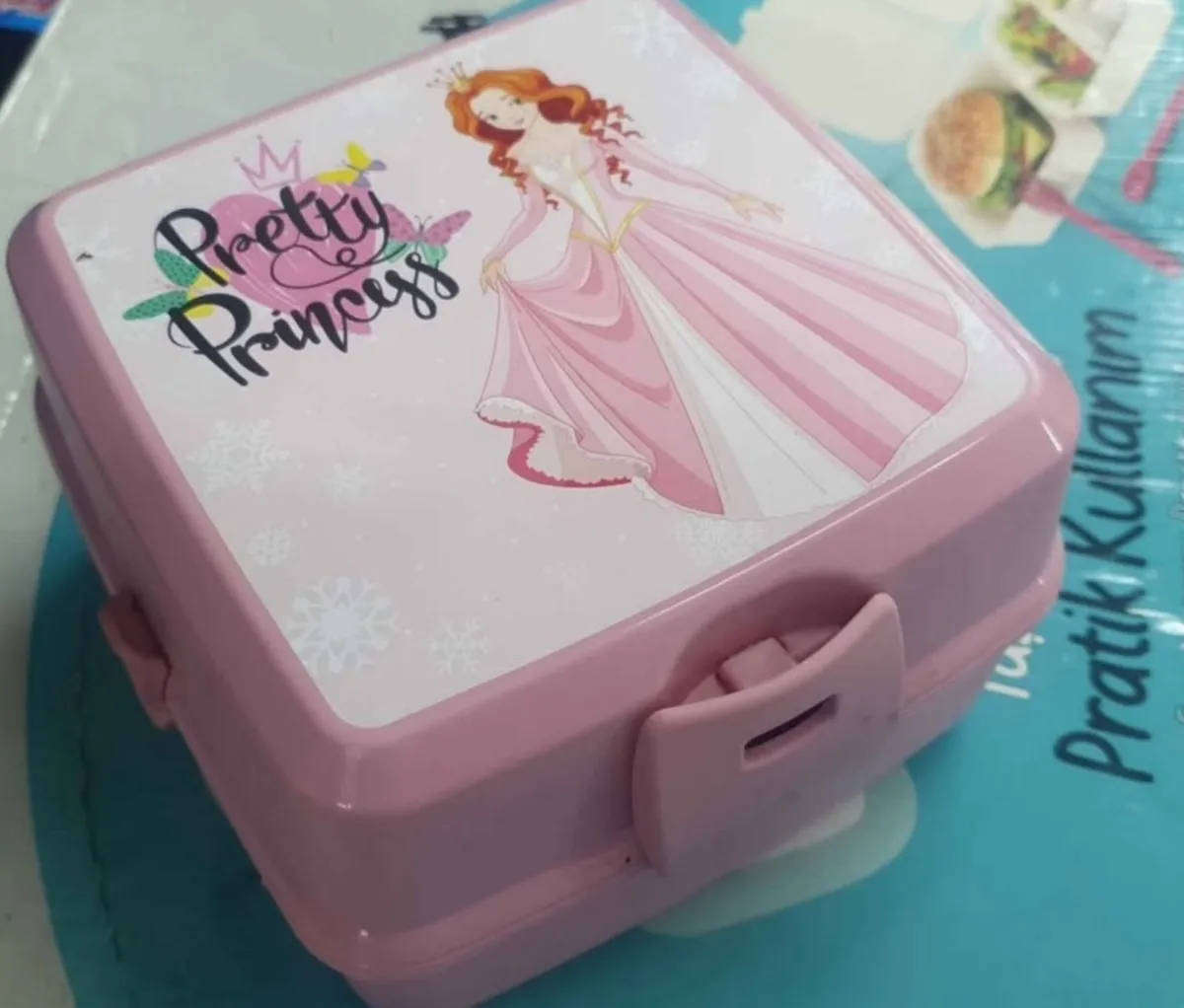 Pink Bento style layered lunchbox with utensils